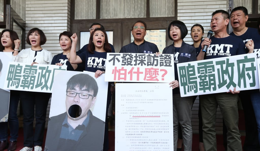 Opposition Kuomintang lawmakers protest outside parliament calling for government legislator Tuan Yi-kang to apologise for calling military veteran demonstrators greedy. Photo: CNA