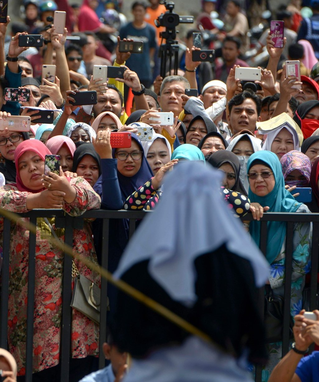 Crowds gather to witness a public flogging. Photo: AFP Crowds gather to witness a public flogging. Photo: AFP