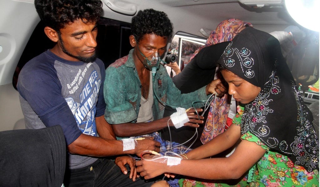 Rohingya Muslims receive medical treatment in an ambulance in Bireuen. Photo: Reuters