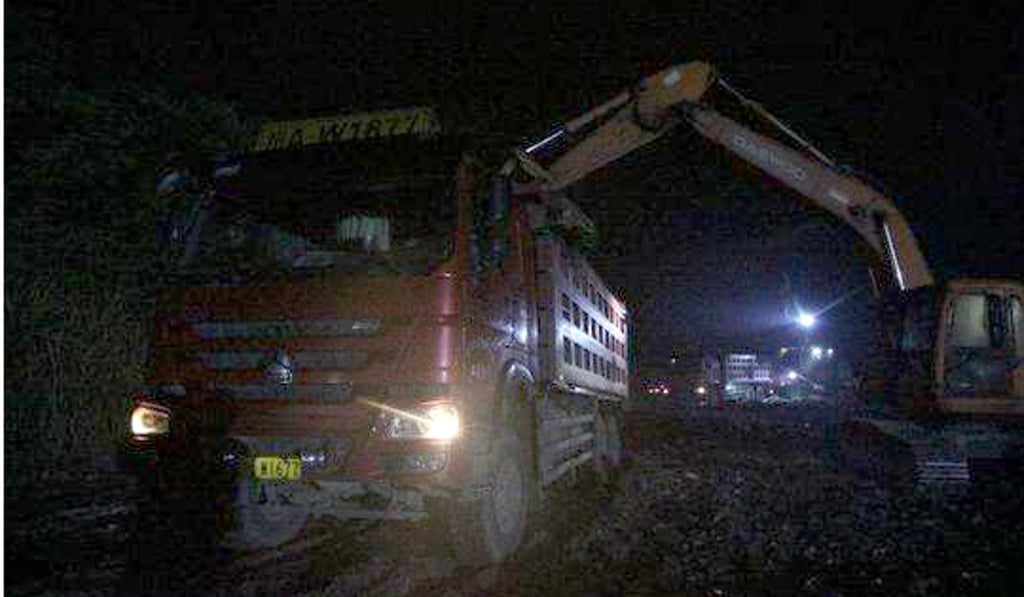 Clean-up crews clear some of the piles of rubbish at the site. Photo: Sina
