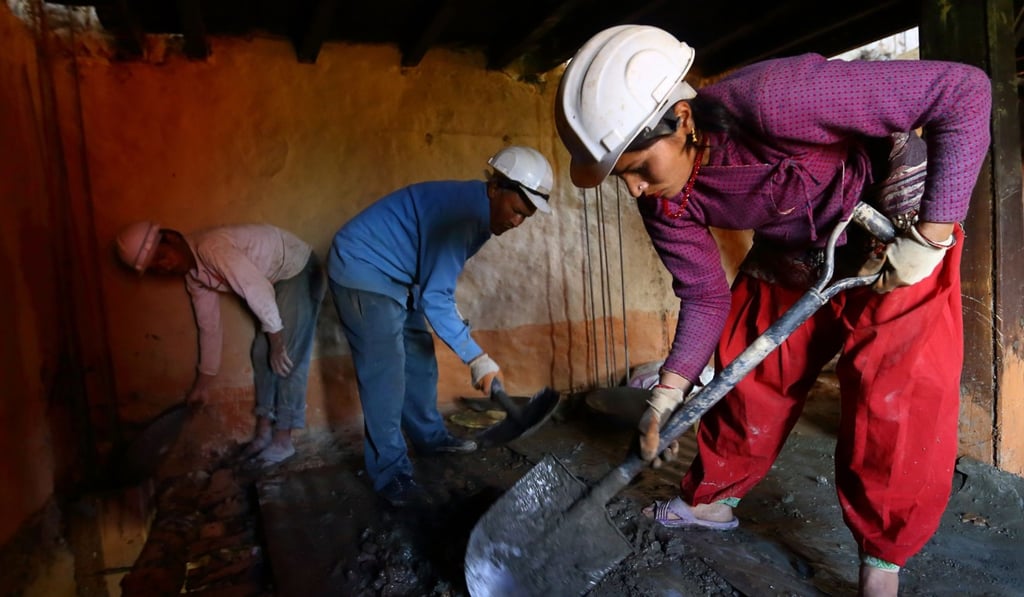 Workers retrofit an earthquake-damaged house. Photo: AFP Workers retrofit an earthquake-damaged house. Photo: AFP