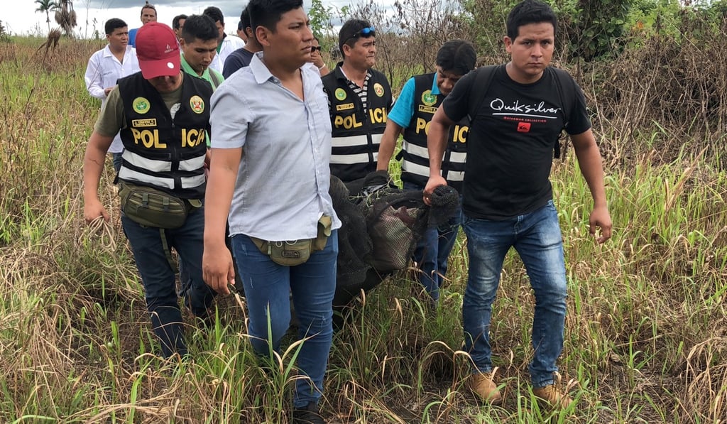 Police officers carry the body of Sebastian Woodroffe, a 41-year-old Canadian, who was beaten and strangled in the jungle region of Ucayali, Peru, on Friday after members of an indigenous community accused him of killing a revered medicine woman. Photo: Reuters