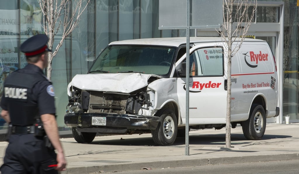 A rented van sits on a sidewalk in Toronto after it was used to run down pedestrians, killing nine. Police arrested the driver. Photo: EPA A rented van sits on a sidewalk in Toronto after it was used to run down pedestrians, killing nine. Police arrested the driver. Photo: EPA