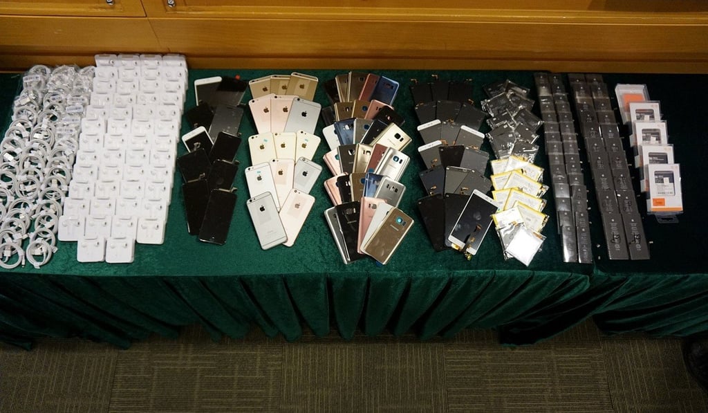More than 3,000 counterfeit accessories and 100 used smartphones being sold as new were seized. Photo: Handout