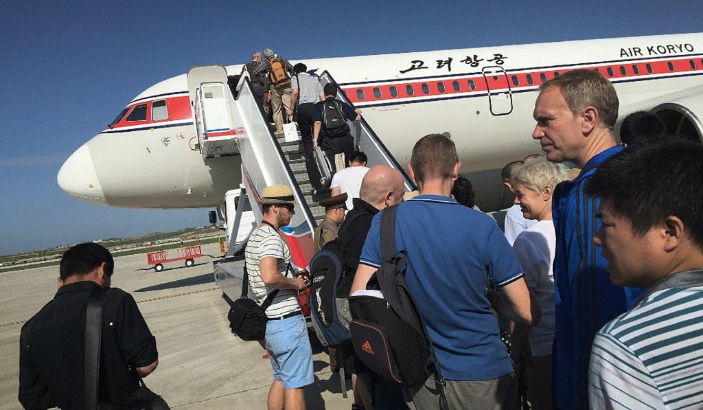 Tourists board an Air Koryo plane at Pyongyang International Airport. Picture: AP Tourists board an Air Koryo plane at Pyongyang International Airport. Picture: AP