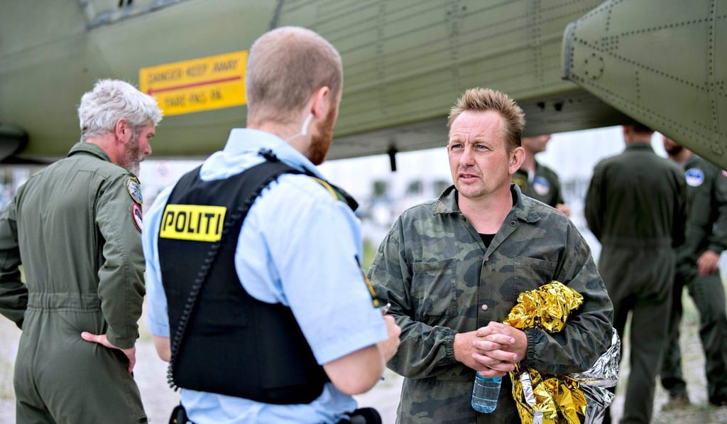 Peter Madsen (right), the builder and captain of the private submarine UC3 Nautilus talking to a police officer following a rescue operation after the submarine sank in the sea outside Copenhagen Harbour. Photo: AFP