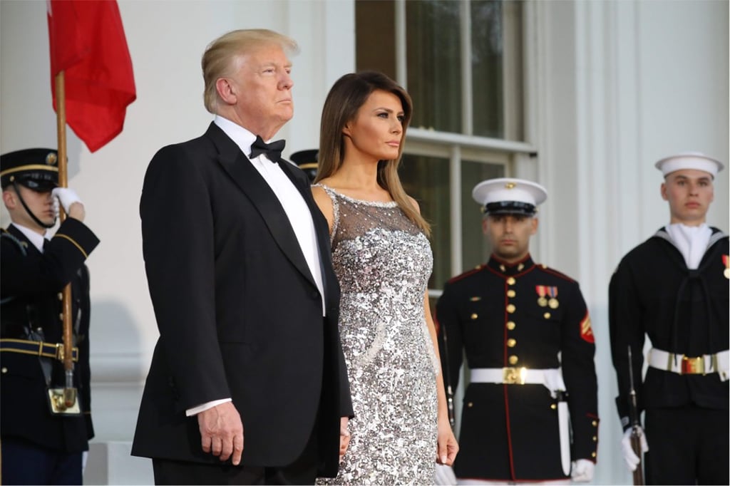 US President Donald Trump and First Lady Melania Trump, dressed in a Chantilly lace Chanel gown, await French President Emmanuel Macron and his wife, Brigitte Macron, before the state dinner at the White House in Washington. Photo: AFP