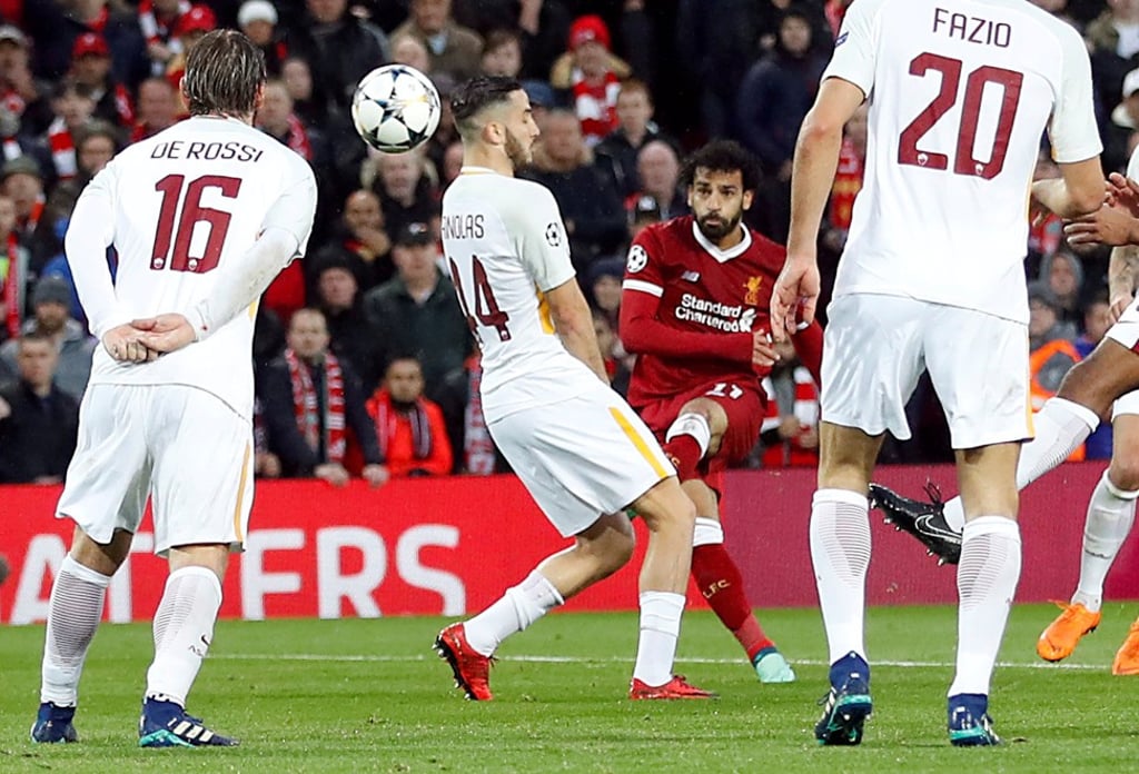 Mohamed Salah cuts in from the right and curls home the first goal. Photo: Reuters