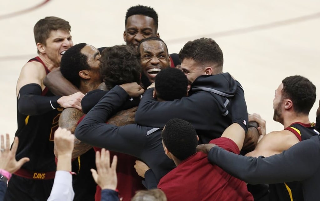 LeBron James is mobbed by his teammates after making the game-winning shot. Photo: EPA LeBron James is mobbed by his teammates after making the game-winning shot. Photo: EPA