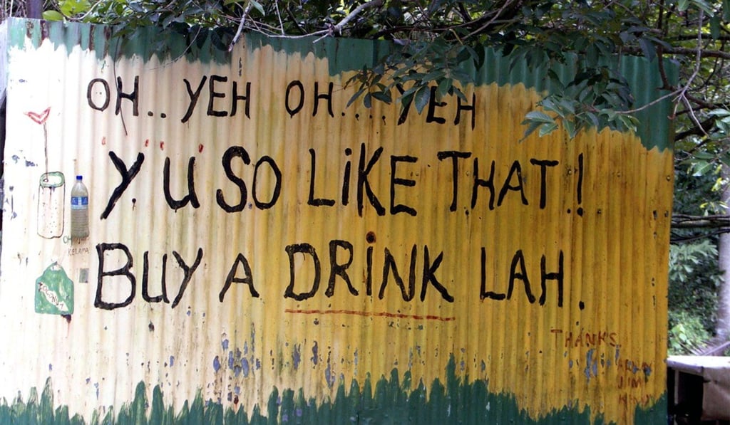 An example of Singlish on a corrugated iron fence in Singapore.