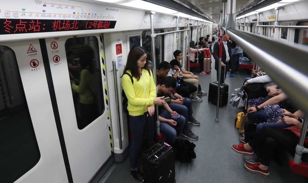 Passengers take the subway to the new airport terminal in Guangzhou on Thursday. Photo: Edward Wong