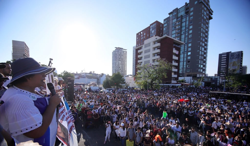 Thousands of people march during a protest against the murders. Photo: EPA Thousands of people march during a protest against the murders. Photo: EPA