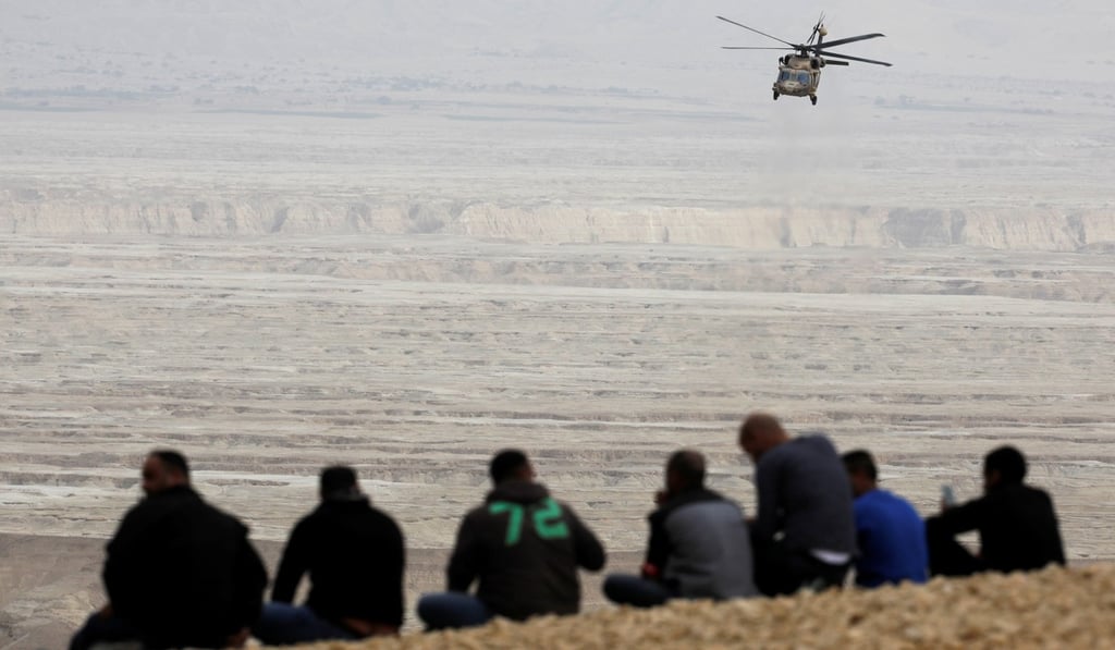 An Israeli rescue services helicopter operates near the site where a group of Israeli hikers was swept away by a flash flood, near the Zafit riverbed, south of the Dead Sea, on Thursday. Photo: Reuters