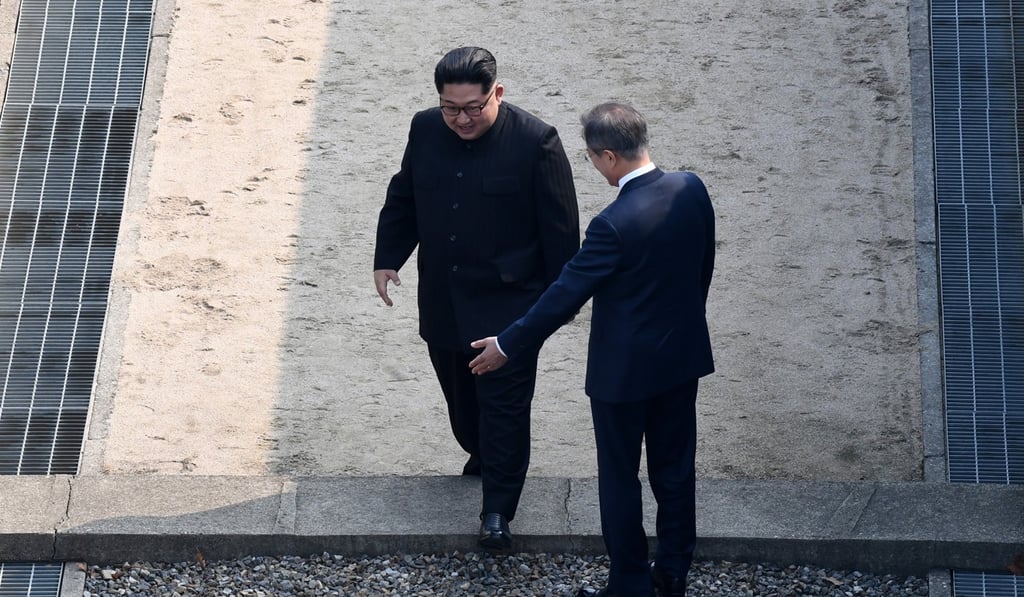 North Korean leader Kim Jong-un crosses the military demarcation line as South Korean President Moon Jae-in greets him in the demilitarised zone in the border village of Panmunjom. Photo: EPA