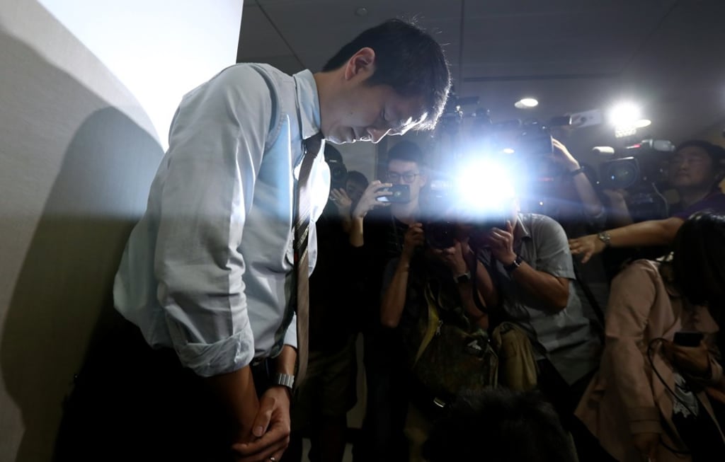 Ted Hui Chi-fung from the Democratic Party, is photographed bowing in apology at the Legislative Council Complex in Tamar on Thursday. Photo: Nora Tam