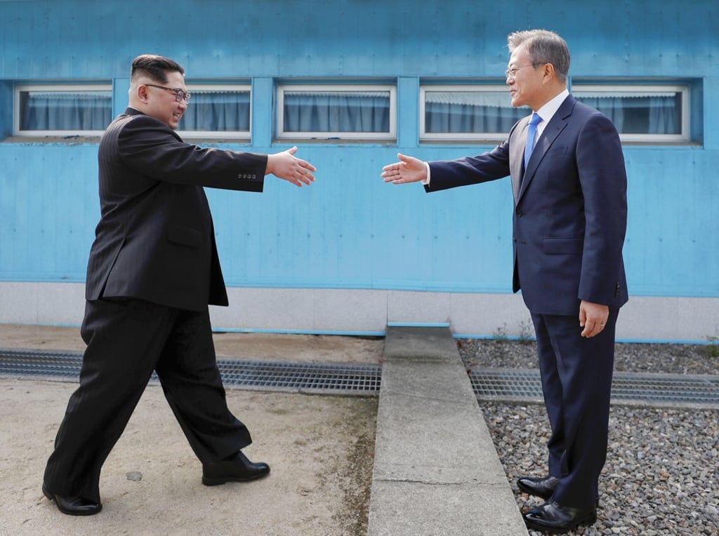 North Korean leader Kim Jong-un (left) and South Korean President Moon Jae-in greet each other at the border between their two countries in Panmunjom on Friday. Photo: Kyodo North Korean leader Kim Jong-un (left) and South Korean President Moon Jae-in greet each other at the border between their two countries in Panmunjom on Friday. Photo: Kyodo
