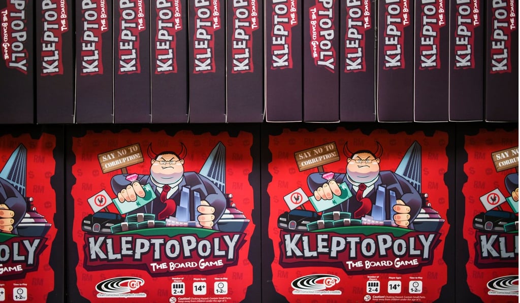 Boxes for the ‘Kleptopoly’ board game. Photo: AFP