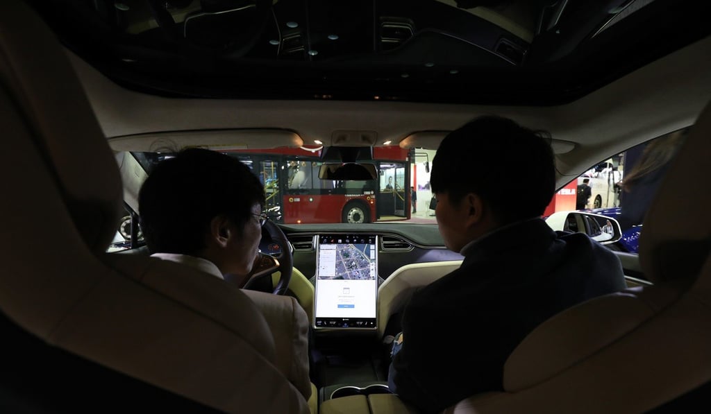 Attendees sit inside a Tesla Model S at the EV Trend Korea exhibition in Seoul, South Korea, on Thursday, April 12. Photo: Bloomberg
