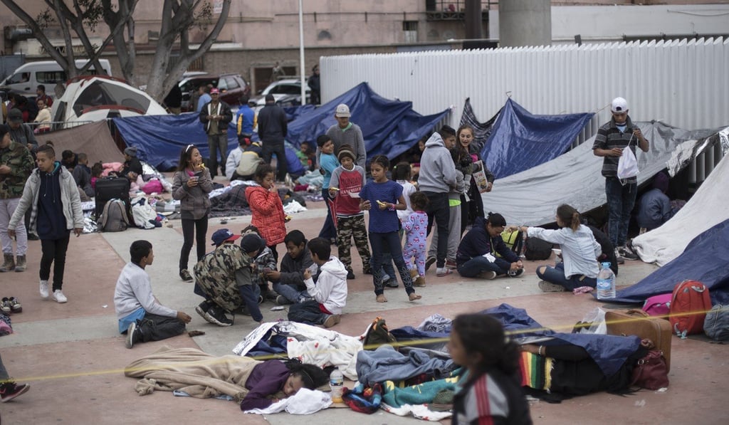 Migrants wait for access to request asylum in the US at the El Chaparral port of Entry in Tijuana, Mexico, on Monday. Photo: AP Migrants wait for access to request asylum in the US at the El Chaparral port of Entry in Tijuana, Mexico, on Monday. Photo: AP
