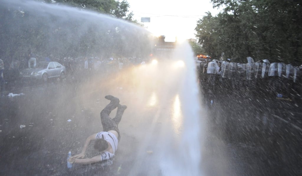 An Armenia protester is hit by water cannon. Photo: Reuters. An Armenia protester is hit by water cannon. Photo: Reuters.