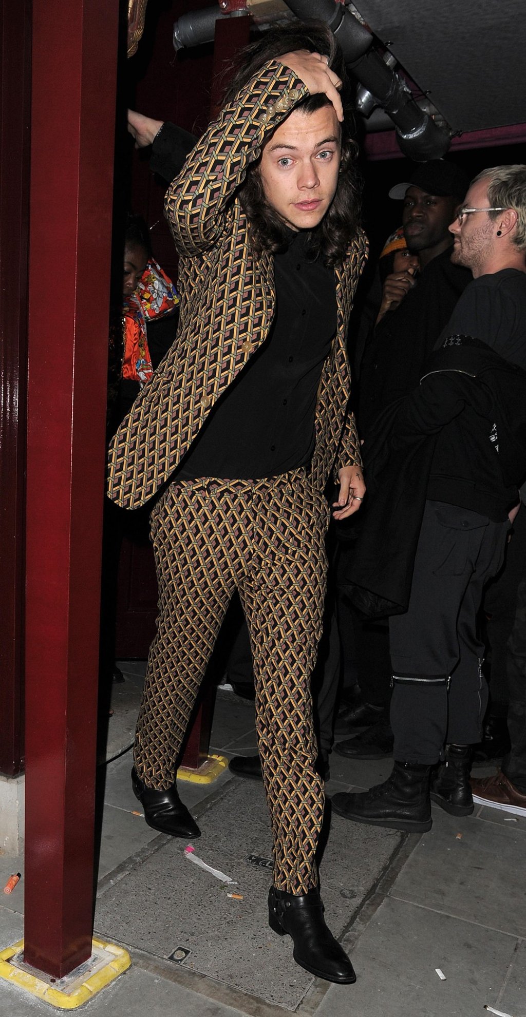 Styles wearing a geometric-pattern Gucci suit in London in 2016. Photo: Alamy