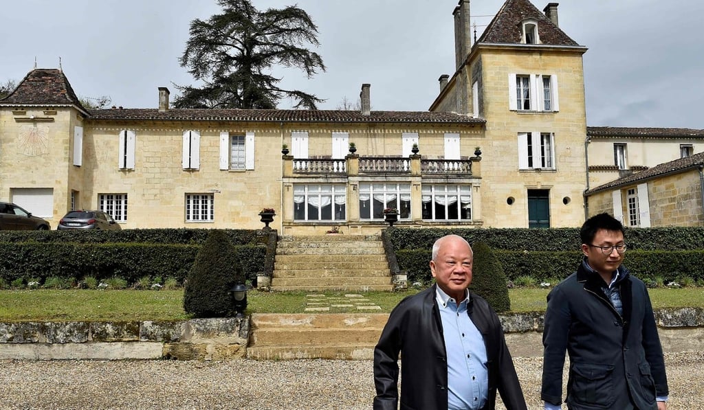 Peter Kwok walks with his son Howard in the gardens at the Chateau Bellefont-Belcier, in Saint-Laurent-des-Combes, on April 11. Photo: Agence France-Presse
