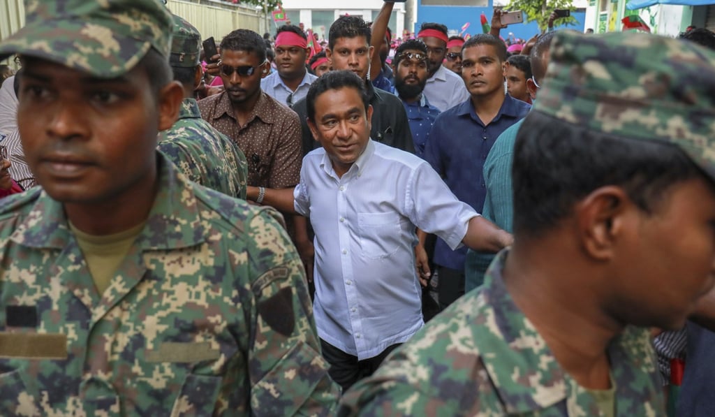 President Abdulla Yameen of the Maldives is surrounded by his bodyguards as he arrives to address his supporters in Male, Maldives. Photo: AP