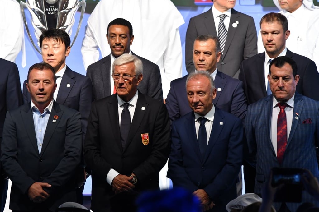 Marcello Lippi (second left, front) poses with the other national team coaches at the end of the draw for the AFC Asian Cup.