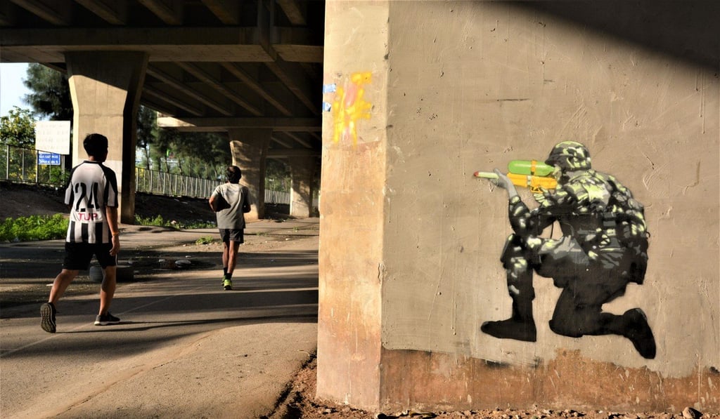 A painting of a Thai army soldier created by Headache Stencil in Bangkok. Photo: Tibor Krausz