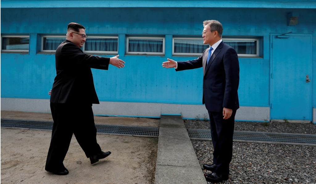 South Korean President Moon Jae-in and North Korean leader Kim Jong-un greet one another for the first time in the demilitarised zone on April 27. Photo: Reuters