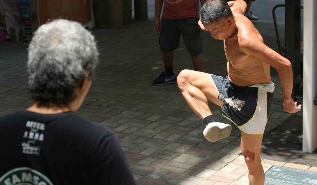 Players demonstrate their lunchtime skill in the shuttlecock kicking game. Photo: Edmond So