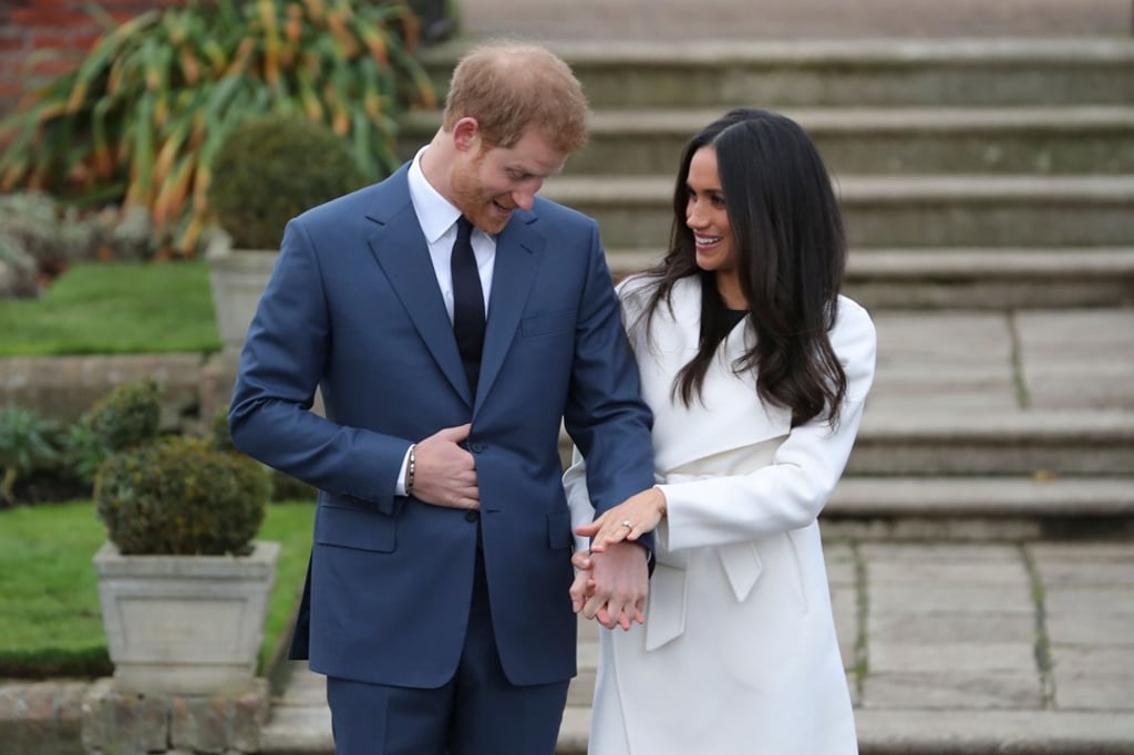Britain’s Prince Harry with his fiancée Meghan Markle as she shows off her engagement ring. Photo: AFP Britain’s Prince Harry with his fiancée Meghan Markle as she shows off her engagement ring. Photo: AFP