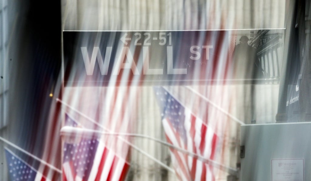 A sign for Wall Street outside the New York Stock Exchange. The exodus of major companies from the area around the bourse to Midtown began in the 1970s, as computerised trading freed banks and brokerages from having to deliver paper securities and cheques. Photo: EPA-EFE