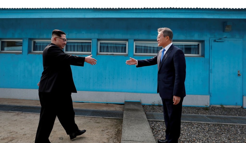 North Korean leader Kim Jong-un and South Korean President Moon Jae-in approach each other for the famed handshake at the truce village of Panmunjom inside the demilitarised zone. Photo: Reuters