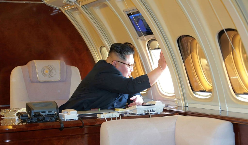 Kim Jong-un waves to Chinese officials in a photo apparently taken ahead of his departure from Dalian on Tuesday. Photo: AFP/ KCNA via KNS