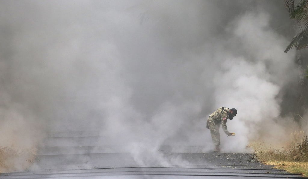 A US Army National Guard member measures sulfur dioxide gas at volcanic fissures in the Leilani Estates neighbourhood on Tuesday in the aftermath of eruptions from the Kilauea volcano on Hawaii's Big Island. Photo: Getty Images via AFP A US Army National Guard member measures sulfur dioxide gas at volcanic fissures in the Leilani Estates neighbourhood on Tuesday in the aftermath of eruptions from the Kilauea volcano on Hawaii's Big Island. Photo: Getty Images via AFP
