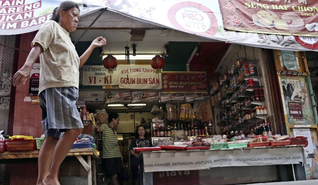 A woman walks past a shop in Jakarta’s Chinatown in November 2016. Indonesian President Joko Widodo’s good relations with China may be used by opposition politicians to play up anti-Chinese sentiment in Indonesia. Photo: AP