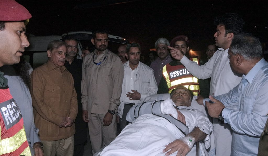 Pakistan’s Interior Minister Ahsan Iqbal arrives in Lahore after being shot in the arm in a suspected assassination attempt. Photo: AFP