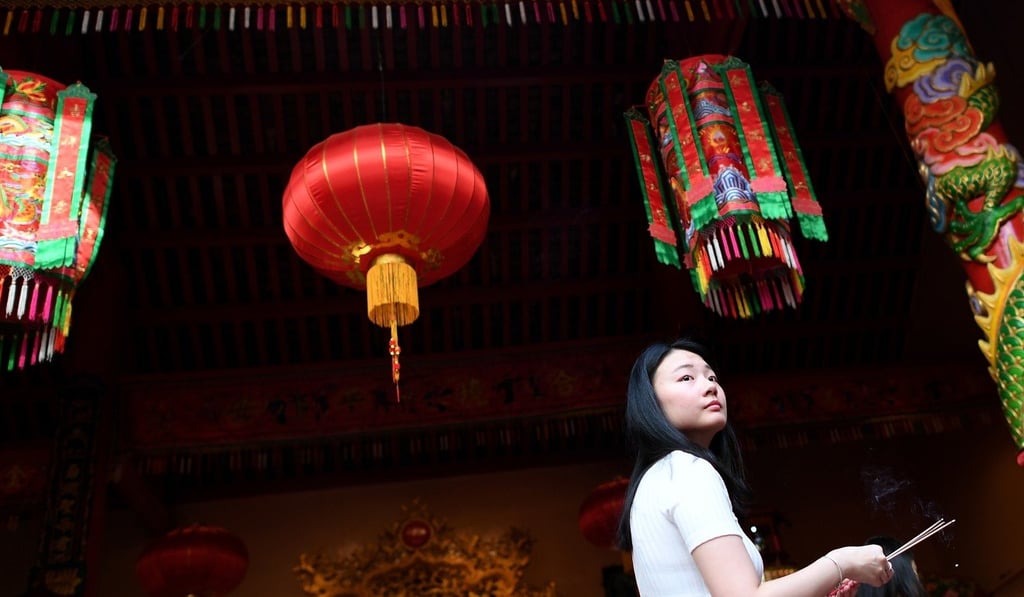 A woman offers prayers at a temple in Kualar Lumpur’s Chinatown area on the first day of the Lunar New Year last year. Photo: AFP