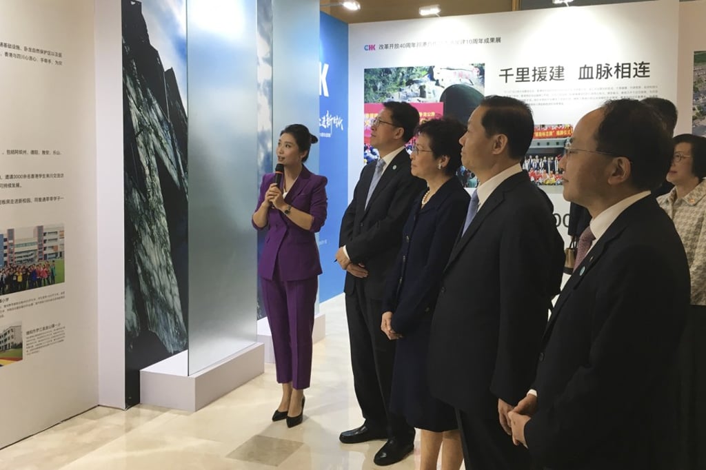 Carrie Lam (centre) is given a tour of an exhibition of Hong Kong-funded reconstruction projects in Sichuan after the earthquake. Photo: Sarah Zheng