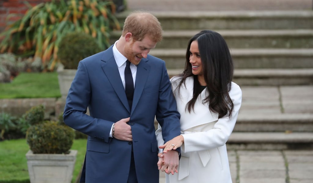 Britain's Prince Harry stands with his fiancée, US actress Meghan Markle, in the Sunken Garden at Kensington Palace in west London on November 27, 2017, following the announcement of their engagement. Photo: AFP