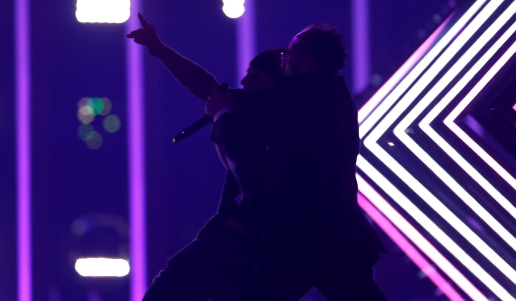 Security subdues a person who invaded the stage as SuRie performed ‘Storm’ in the Eurovision final.  The man shouted ‘Nazis of the UK media, we demand freedom’ before being dragged off. Photo: Reuters