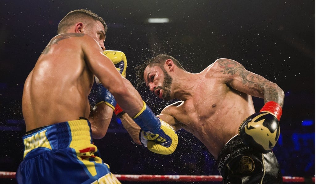 Vasiliy Lomachenko tries to avoid a punch from Jorge Linares. Photo: AP