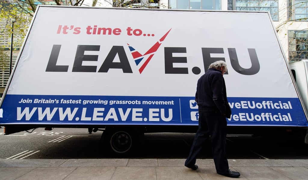 A man walks past a campaign poster in London in November 2015, ahead of the referendum held in June 2016, in which a majority of Britons voted to leave the European Union. Photo: AFP