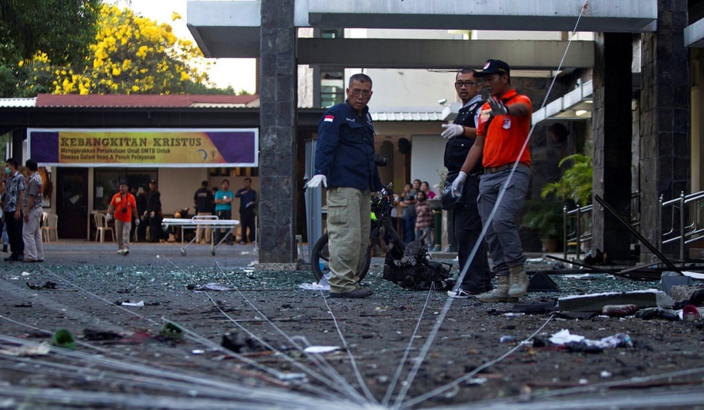 A police forensic team examine the scene of a bomb at a church in Surabaya. Photo: Reuters