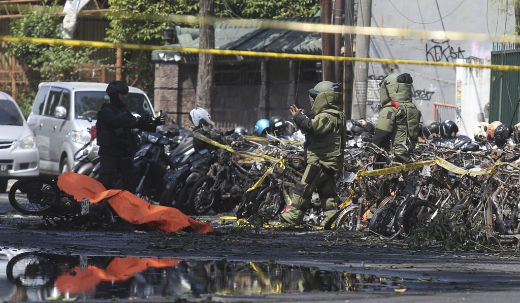 Members of the police bomb squad inspect a wreckage motorcycles. Photo: AP
