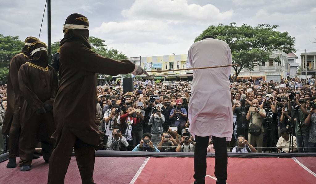 A man convicted of having gay sex is caned outside a mosque in Banda Aceh, Aceh province, Indonesia, in May 2017. Photo: AP