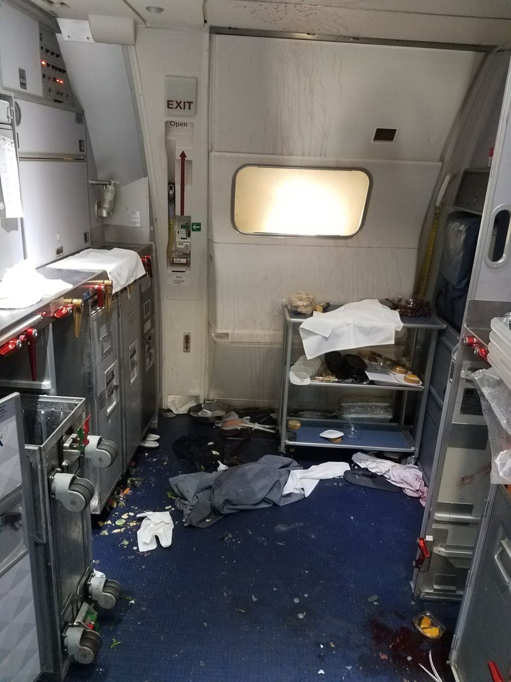 This July 7, 2017, photo taken the FBI and released via the US Attorney's Office in Seattle shows the cabin of Delta Flight 129 from Seattle to Beijing, after authorities say flight attendants struggled to restrain Joseph Daniel Hudek IV after he lunged for an exit door. Red wine can be seen on the ceiling; a bottle was smashed over Hudek’s head. Photo: AP