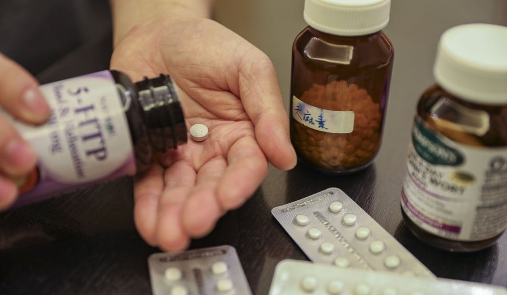 Derek Chan with supplements and medicines he used to treat his depression. Photo: Simon Song