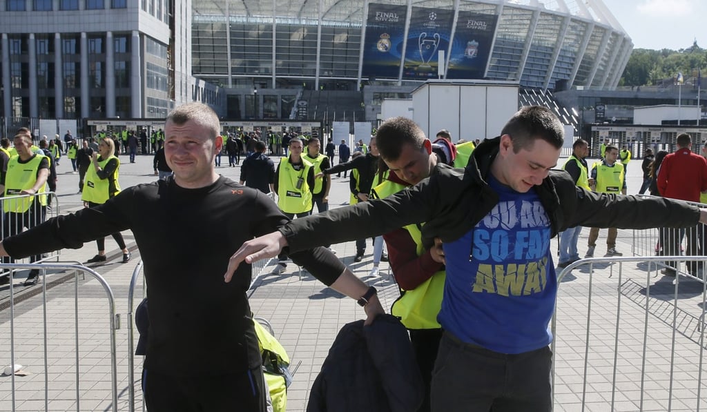Security service workers check people acting as fans during security training in front of the NSC Olimpiyskiy stadium, venue of the Champions League final, in Kiev, Ukraine. Photo: EPA